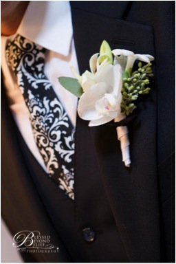 Designed by Laurie of Fleurie, Reedley, California. 1 Phalaenopsis floret 1 Stephanotis 1 Dendrobium bud Seeded Eucalyptus Dusty Miller leaf Ribbon $20. (Photograph of Blessed Beyond Belief )