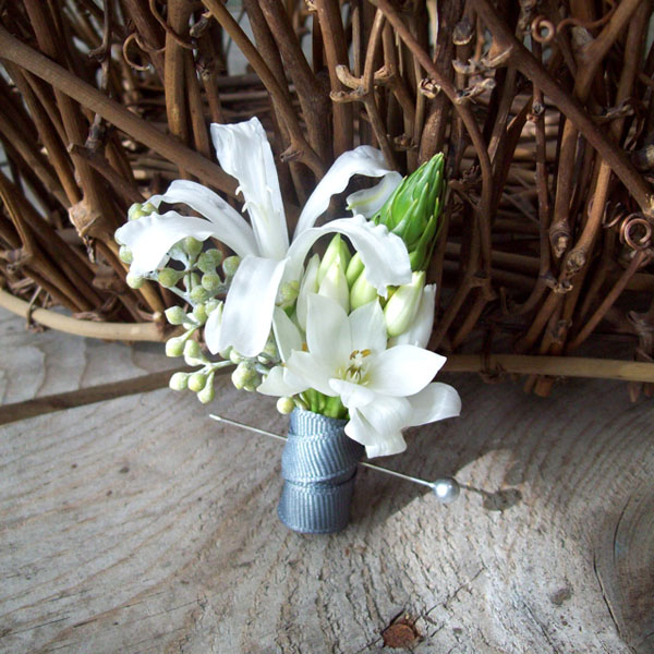 Designed by Holly of Sweet Pea Floral Design, Michigan. (www.sweetpfloral.com) Nerine lily Star of Bethlehem Seeded Eucalyptus Grey Grosgrain Ribbon Silver Boutonniere pin $17.50