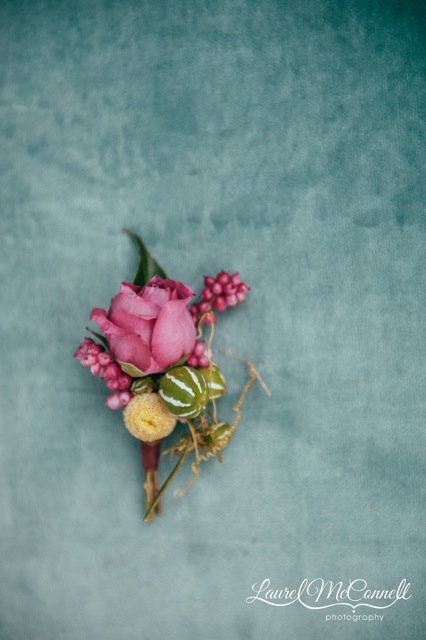 Floressence, boutonniere of a rose and cucumis