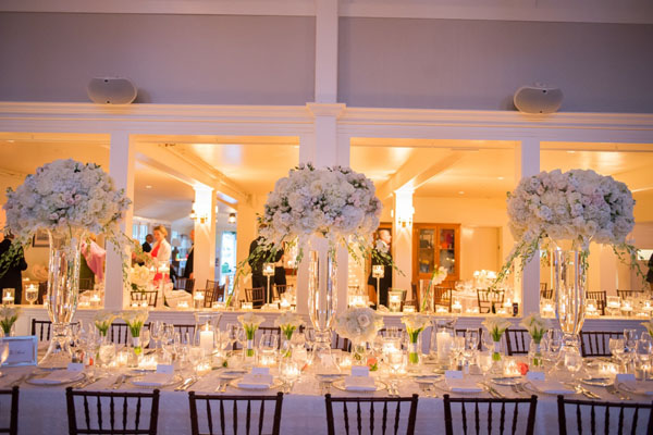 Brea McDonald Photography and Soiree Floral of Nantucket, Elevated centerpieces of white flowers that include roses, hydrangeas and dendrobrium orchids