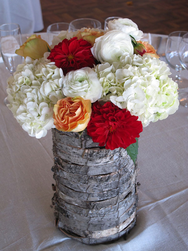 rustic centerpiece with white red and orange flowers