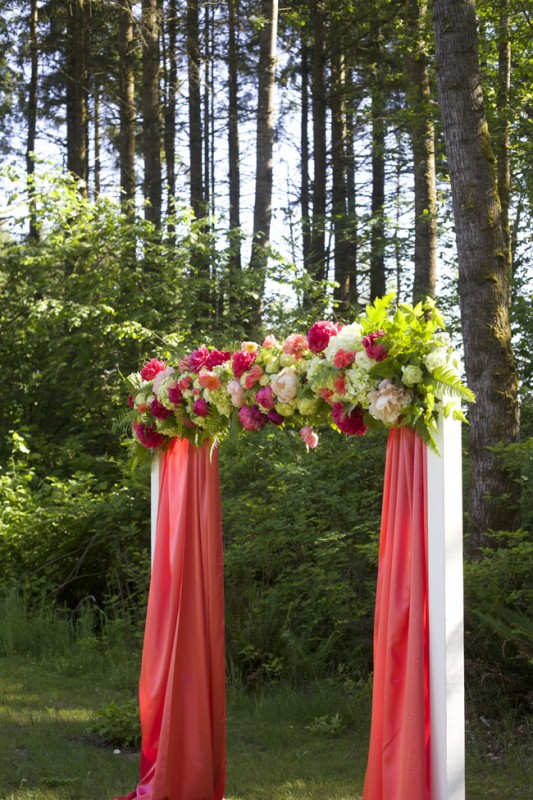 Modern Floral Arch with coral fabric, green, coral and peach flowers for the Flirty Fleurs Floral Design Class in Washington.