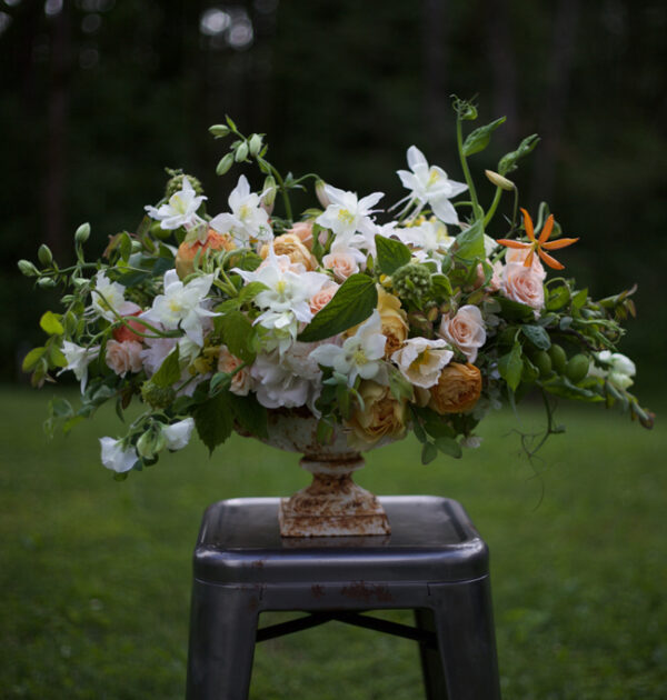 Bella Fiori - urn arrangement with peach and white flowers, including columbines.