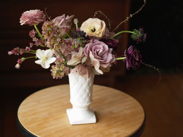 Amanda at Alluring Blooms, Wisconsin, milk glass with a lavender floral arrangement