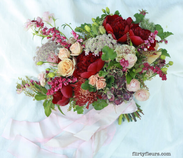 flirty fleurs bridal bouquet with red peonies
