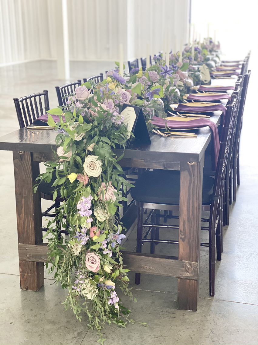 Jessica Jones Blooms N Blossoms Wedding Florist Kentucky  - garland of flowers down the center of a long reception table