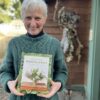 Francoise Weeks holding her book Wonder of the Woodlands, the art of seeing and creating with nature